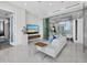 Modern living room with white leather sofa, an entertainment center with large screen tv and views from the balcony at 50 Central Ave # 17Phd, Sarasota, FL 34236