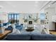 Elegant living room featuring a fireplace, comfortable blue sofas, and panoramic views from large windows at 50 Central Ave # 17Phd, Sarasota, FL 34236