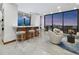 Elegant living space with a modern wet bar, plush seating, and panoramic city views through large windows at 50 Central Ave # 17Phd, Sarasota, FL 34236
