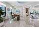 Open-concept living area with marble floors, desk, and chandelier at 50 Central Ave # 17Phd, Sarasota, FL 34236