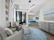 Comfortable sitting area with chairs, a contemporary chandelier, balcony access, and views into a bedroom at 50 Central Ave # 17Phd, Sarasota, FL 34236