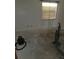 Empty bedroom featuring a window and bare concrete flooring at 519 36Th E Ave, Bradenton, FL 34208