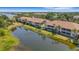 Aerial view showcasing the condos and the serene pond views with multiple buildings at 5633 Key Largo Ct # B-08, Bradenton, FL 34203