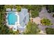 Aerial view of the community pool, building and spa surrounded by green trees at 5633 Key Largo Ct # B-08, Bradenton, FL 34203