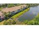Aerial view of condos overlooking the pond, showing expansive screened patios and beautiful landscaping at 5633 Key Largo Ct # B-08, Bradenton, FL 34203