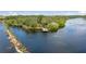 Aerial view showcases a tranquil waterfront community with a fishing pier at 5633 Key Largo Ct # B-08, Bradenton, FL 34203
