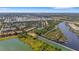 Expansive aerial view of a community surrounded by waterways, lush landscapes and bridges under a clear sky at 5633 Key Largo Ct # B-08, Bradenton, FL 34203