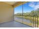 Serene screened balcony overlooking a tranquil waterway and lush greenery at 5633 Key Largo Ct # B-08, Bradenton, FL 34203