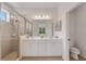 Bright bathroom features a double sink vanity and a glass enclosed shower at 5633 Key Largo Ct # B-08, Bradenton, FL 34203
