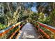 Wooden community bridge walkway nestled among lush greenery and trees at 5633 Key Largo Ct # B-08, Bradenton, FL 34203