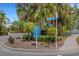 Signage at the community entrance showing various amenities including recreation center, pool, and boat docks at 5633 Key Largo Ct # B-08, Bradenton, FL 34203