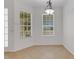 Bright dining room features tile floors, natural light from two windows, and a modern chandelier at 5633 Key Largo Ct # B-08, Bradenton, FL 34203