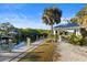 Scenic waterfront view featuring a private boat dock, gazebo, and lush landscaping along the canal at 5633 Key Largo Ct # B-08, Bradenton, FL 34203