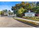 Elegant community entrance with lush landscaping and a welcoming gatehouse, showcasing a well-maintained neighborhood at 5633 Key Largo Ct # B-08, Bradenton, FL 34203