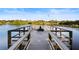 Relaxing fishing pier featuring bench seating and beautiful waterfront views with clear blue sky at 5633 Key Largo Ct # B-08, Bradenton, FL 34203
