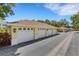 Row of well-maintained detached garages with white doors and beige siding, offering ample parking at 5633 Key Largo Ct # B-08, Bradenton, FL 34203