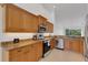 Kitchen features stainless appliances, granite counters, wooden cabinets, and an open design at 5633 Key Largo Ct # B-08, Bradenton, FL 34203