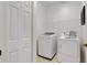 Bright laundry room featuring a modern washer and dryer, shelving, and a closet at 5633 Key Largo Ct # B-08, Bradenton, FL 34203