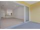 Bright living room and slider to the lanai featuring neutral walls, and view to the kitchen area at 5633 Key Largo Ct # B-08, Bradenton, FL 34203