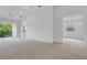 Bright living room with sliding glass doors to balcony, white walls, and view of another room at 5633 Key Largo Ct # B-08, Bradenton, FL 34203