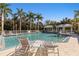 Community pool area featuring comfortable lounge chairs and shaded gazebos, perfect for relaxation at 5633 Key Largo Ct # B-08, Bradenton, FL 34203