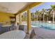 Outdoor pool area offers a covered space for dining with pool views and palm trees at 5633 Key Largo Ct # B-08, Bradenton, FL 34203