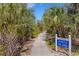 Inviting walking path to John's Island with lush vegetation and a clear blue sky at 5633 Key Largo Ct # B-08, Bradenton, FL 34203