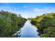 Scenic view of a peaceful waterway surrounded by lush green vegetation under a clear blue sky at 5633 Key Largo Ct # B-08, Bradenton, FL 34203