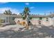 Backyard featuring outdoor seating, a grill, and a white gravel area, with tropical greenery visible at 578-580 Companion Way, Longboat Key, FL 34228