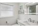 Well-lit bathroom featuring a single sink, framed artwork, and toilet at 578-580 Companion Way, Longboat Key, FL 34228