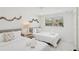 Comfortable bedroom featuring twin beds, neutral decor, and ample natural light at 578-580 Companion Way, Longboat Key, FL 34228