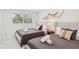 Cozy bedroom with twin beds, soft lighting, and decorative wall art at 578-580 Companion Way, Longboat Key, FL 34228