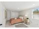 Bright bedroom featuring a queen-size bed, closet, and large window at 578-580 Companion Way, Longboat Key, FL 34228