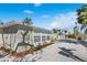 View of the side exterior shows an outdoor seating area, plants, windows, and white gravel landscape at 578-580 Companion Way, Longboat Key, FL 34228