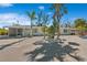 Exterior view of a duplex with white gravel landscaping and blue skies, featuring dual teal doors at 578-580 Companion Way, Longboat Key, FL 34228