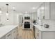 Bright kitchen featuring stainless steel appliances, light countertops, and ample cabinet space at 578-580 Companion Way, Longboat Key, FL 34228