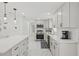 Well-appointed kitchen with stainless steel appliances and crisp white cabinetry at 578-580 Companion Way, Longboat Key, FL 34228