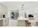Stylish kitchen features stainless appliances, quartz countertops, and adjacent laundry area at 578-580 Companion Way, Longboat Key, FL 34228