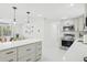 Bright kitchen with stainless steel appliances, quartz countertops, and kitchen island at 578-580 Companion Way, Longboat Key, FL 34228