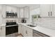 Well-equipped kitchen with stainless steel appliances, white subway tile backsplash, and a modern faucet at 578-580 Companion Way, Longboat Key, FL 34228