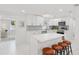 Modern kitchen featuring white cabinets, a large island, stainless steel appliances, and ample counter space at 578-580 Companion Way, Longboat Key, FL 34228