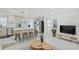 Open-concept living room and kitchen with stainless steel appliances and hardwood floors at 578-580 Companion Way, Longboat Key, FL 34228