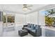 Inviting sunroom with wicker furniture and colorful cushions, bathed in natural light from surrounding windows at 578-580 Companion Way, Longboat Key, FL 34228