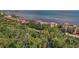 Aerial view of a waterfront condo community surrounded by lush greenery and blue ocean water at 6470 Mourning Dove Dr # 201, Bradenton, FL 34210