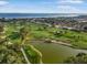 Scenic aerial view of a waterfront golf course and real estate properties near the bay at 6470 Mourning Dove Dr # 201, Bradenton, FL 34210