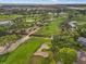 Panoramic aerial view of a lush golf course with mature trees, ponds, and manicured greens at 6470 Mourning Dove Dr # 201, Bradenton, FL 34210