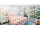 Cozy bedroom with flamingo-themed decor, white seashell headboard and balcony access creating a tropical ambiance at 6470 Mourning Dove Dr # 201, Bradenton, FL 34210