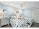 Charming bedroom with two twin beds, blue walls, and white wicker furniture, creating a serene space at 6470 Mourning Dove Dr # 201, Bradenton, FL 34210