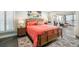 Inviting bedroom featuring a woven-wood bed frame, tropical art, and access to a sunroom at 6470 Mourning Dove Dr # 201, Bradenton, FL 34210