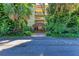 Multi-story condo building surrounded by lush tropical foliage, offering a private and serene setting at 6470 Mourning Dove Dr # 201, Bradenton, FL 34210